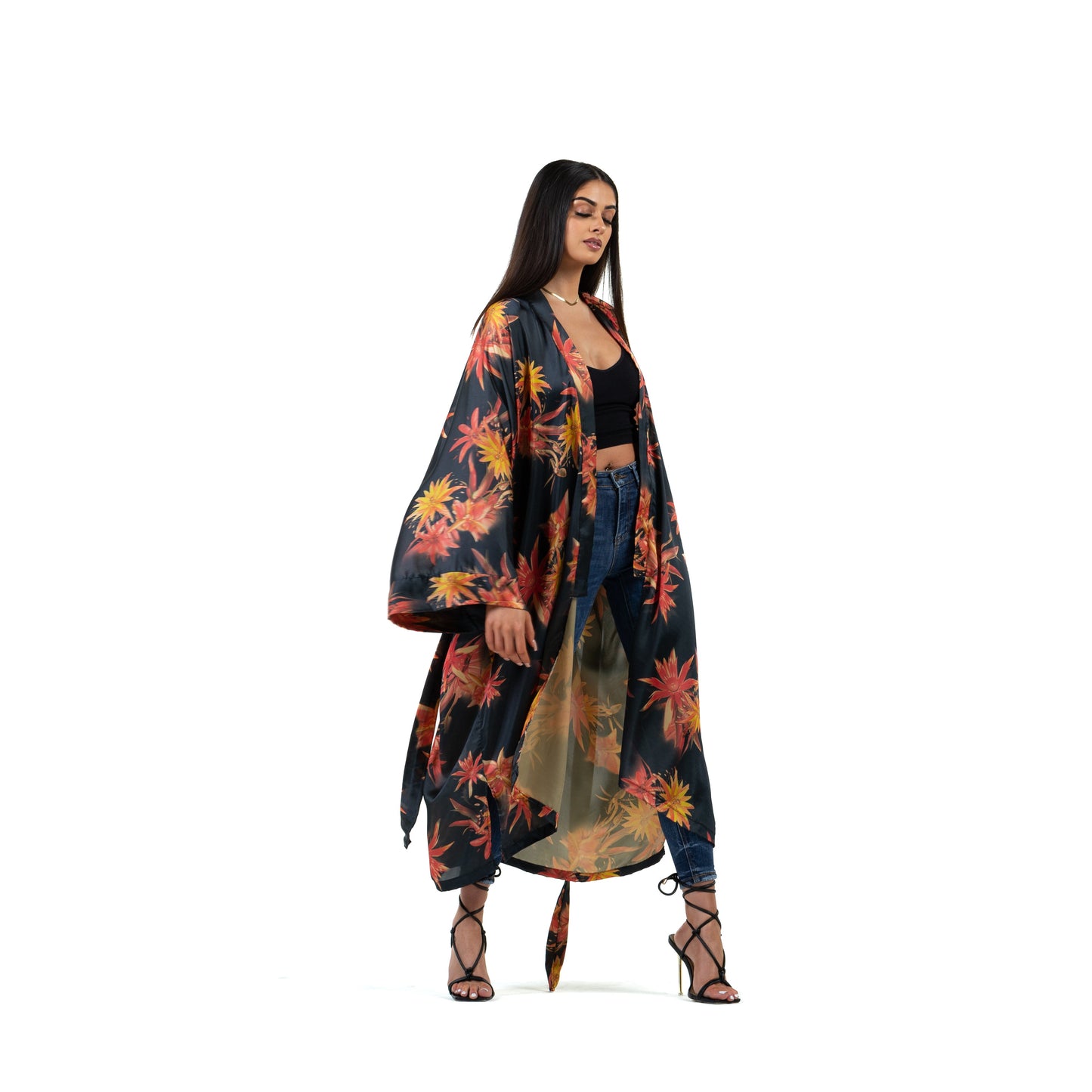 Natalie Anderson Black Satin sunburst kimono with orange and yellow flowers - model shot front view, jeans and heels