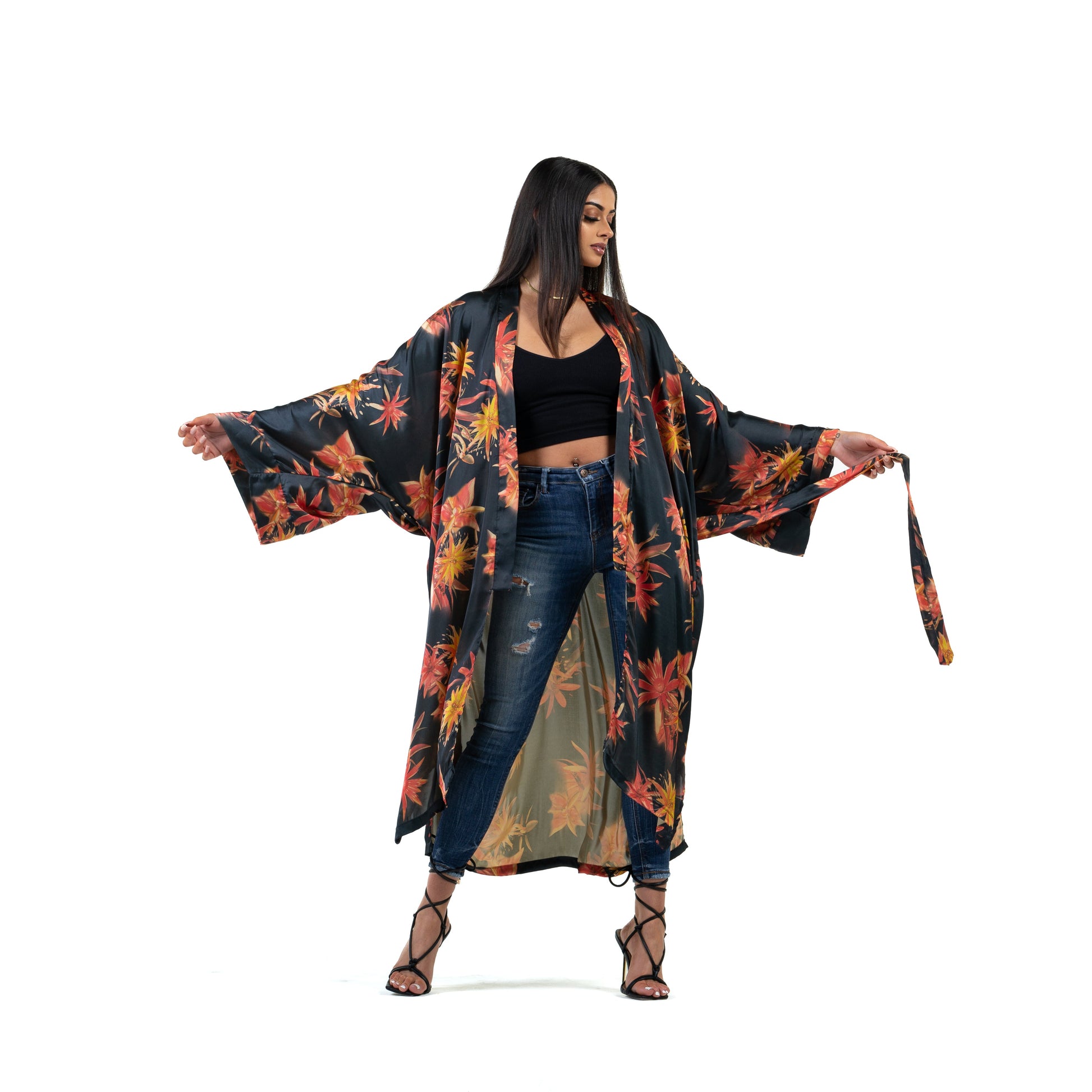 Natalie Anderson Black Satin sunburst kimono with orange and yellow flowers - model shot front view holding belt