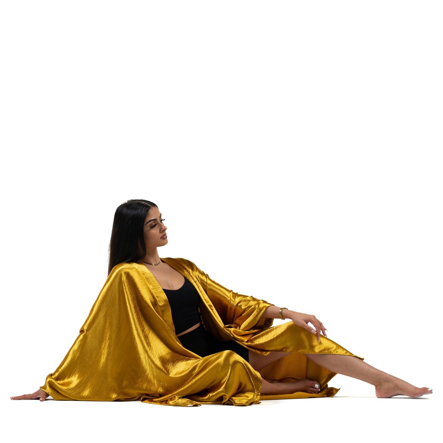 Natalie Anderson Gold liquid satin handmade kimono with full length sleeves and coordinating belt- model lounging floor view