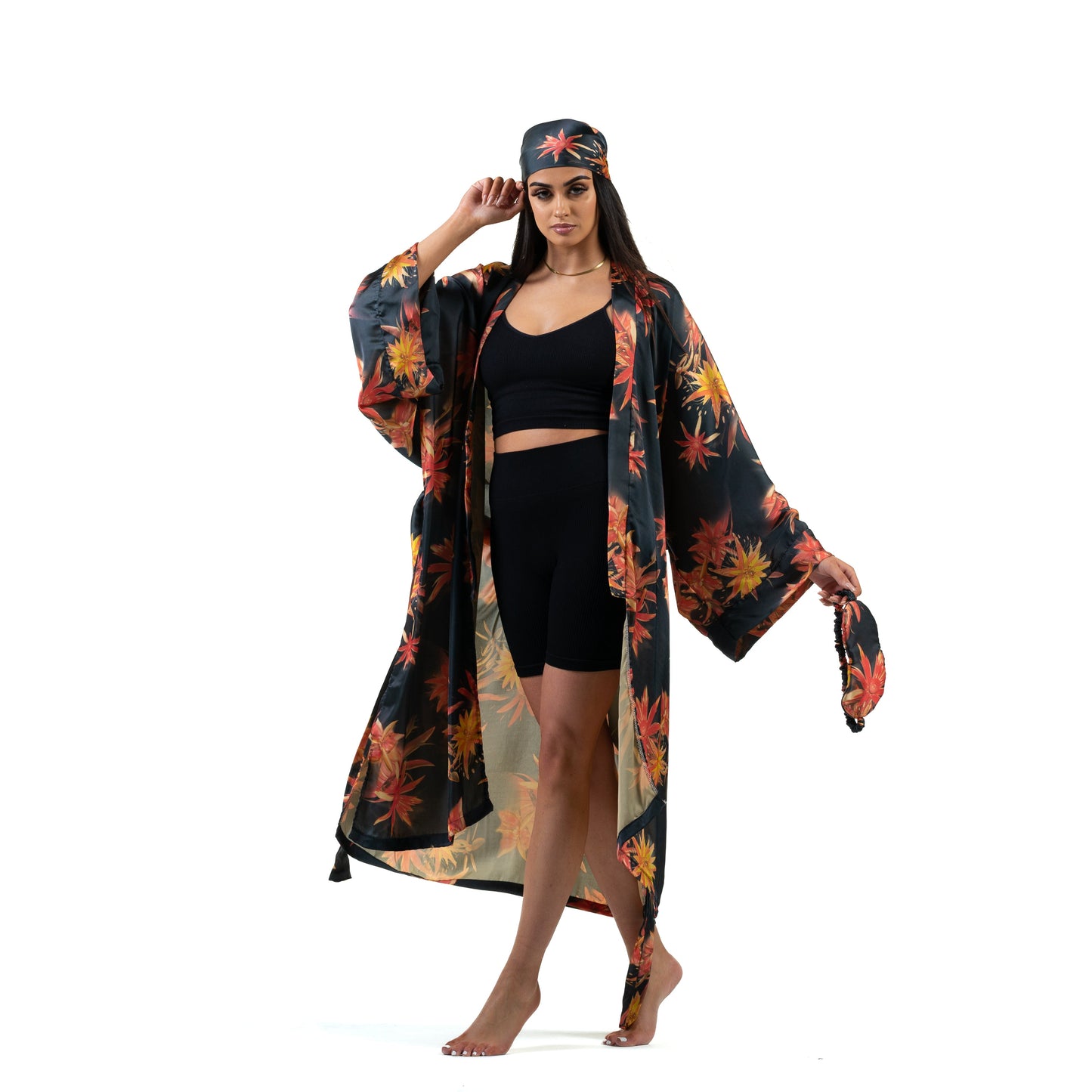 Natalie Anderson Black Satin sunburst kimono with orange and yellow flowers - model shot front view, matching eye mask and hair scarf